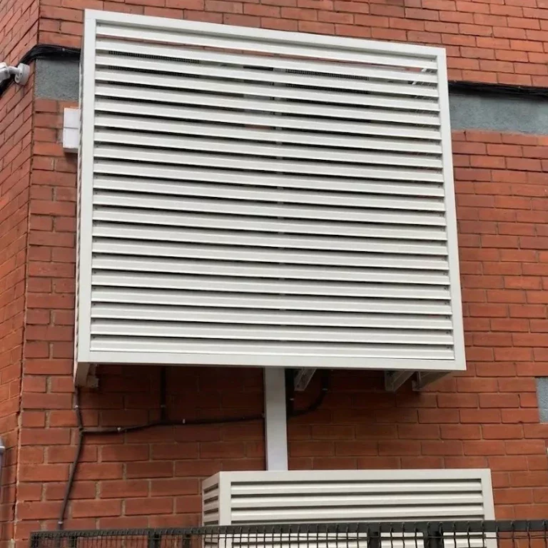 Unidades de aire acondicionado ocultas estéticamente con un jaulón protector de aluminio.